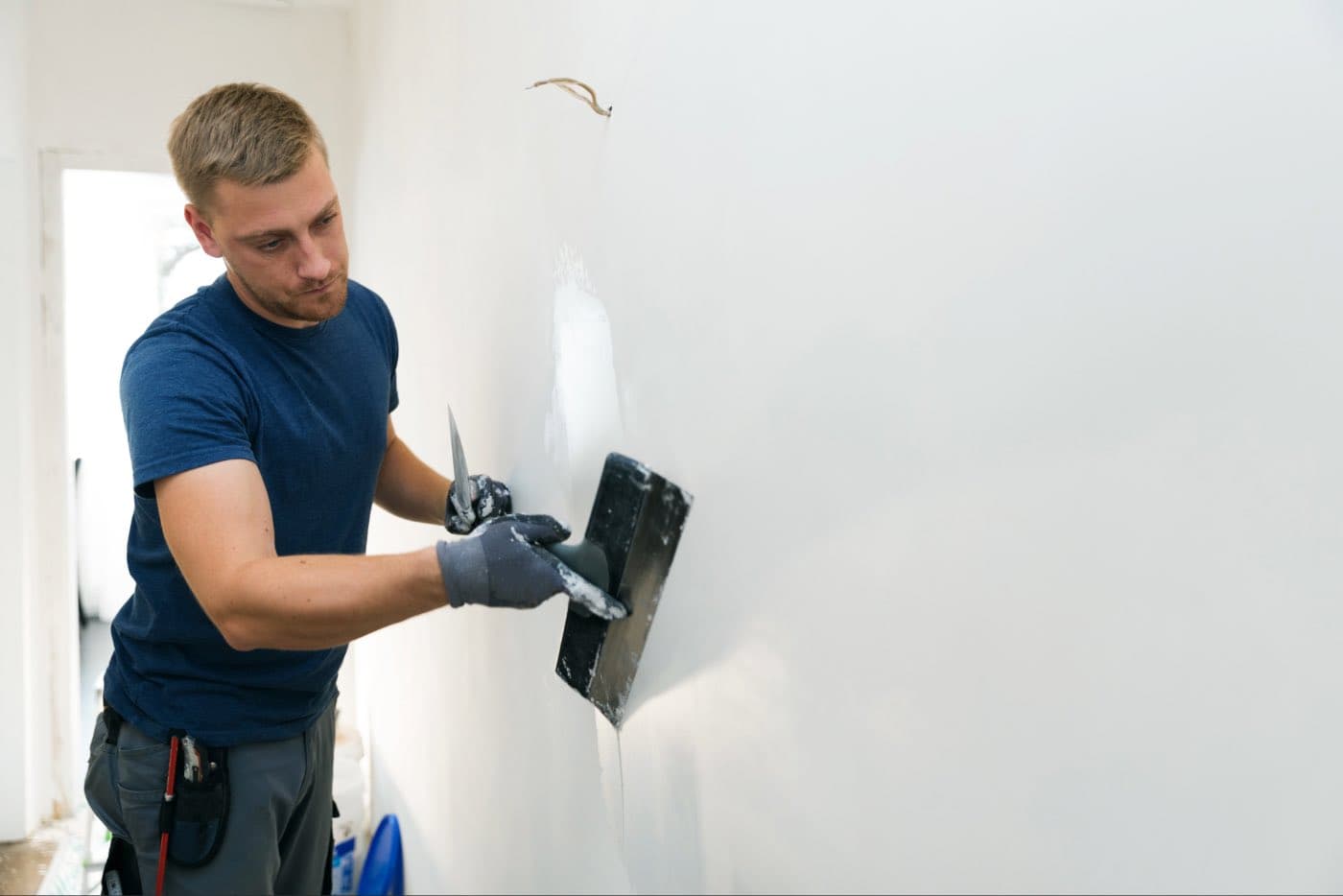 Plasterer skimming an interior wall.